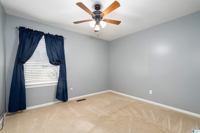 unfurnished room with carpet flooring and ceiling fan