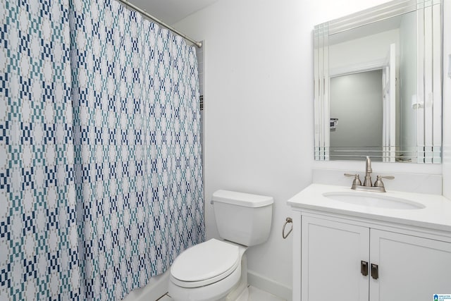 bathroom with vanity, a shower with shower curtain, and toilet