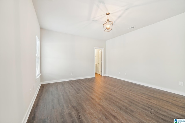 unfurnished room with dark wood-type flooring