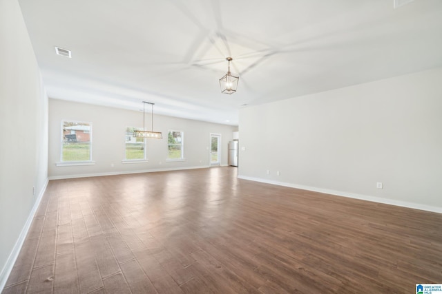 unfurnished living room featuring dark hardwood / wood-style flooring