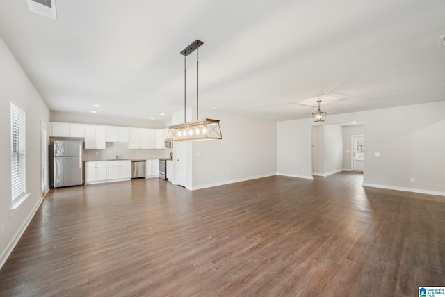 unfurnished living room with dark hardwood / wood-style flooring