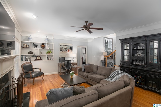 living room with ceiling fan, wood-type flooring, and crown molding