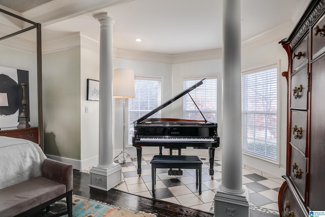 interior space featuring light wood-type flooring, crown molding, and ornate columns