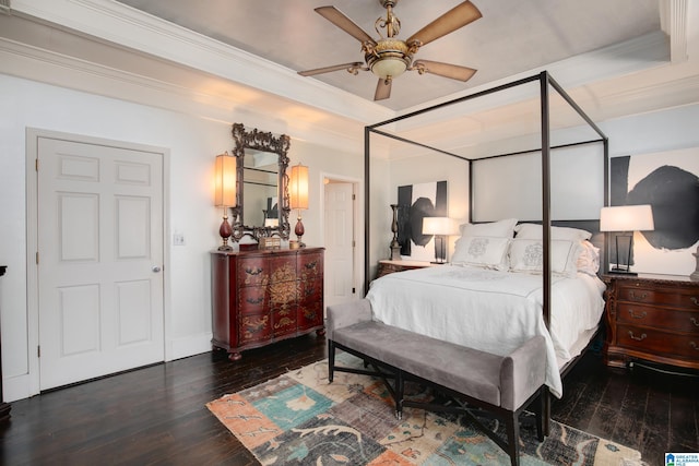 bedroom with ceiling fan, ornamental molding, and dark wood-type flooring