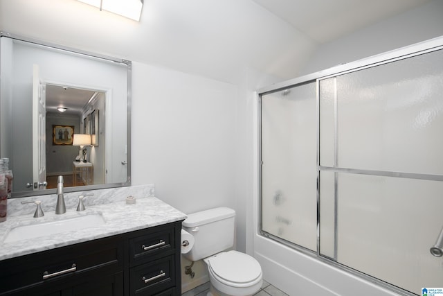 full bathroom with shower / bath combination with glass door, vanity, toilet, and tile patterned flooring