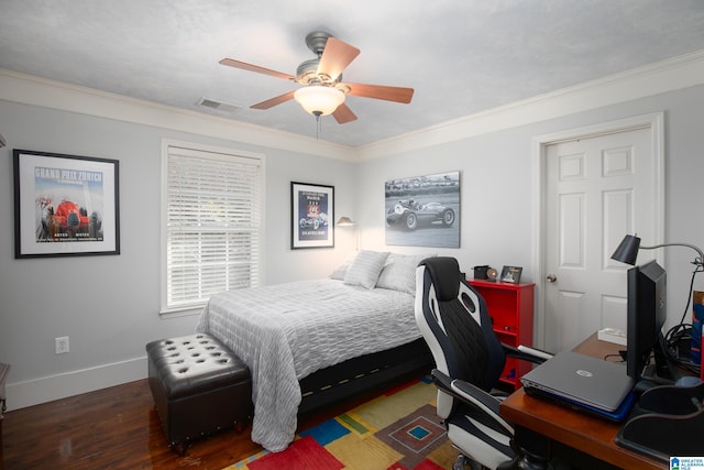 bedroom with dark hardwood / wood-style floors, ceiling fan, and ornamental molding