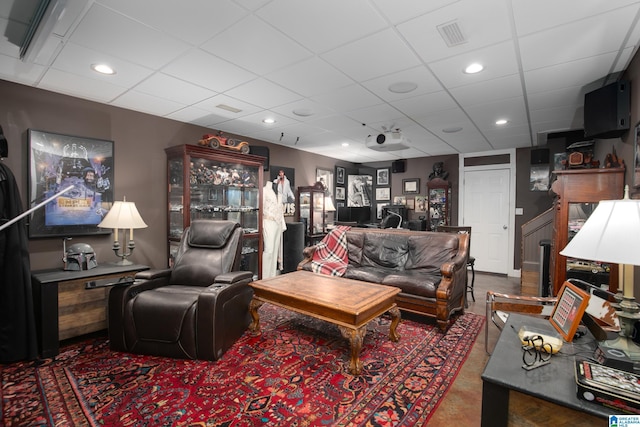 living room featuring a paneled ceiling