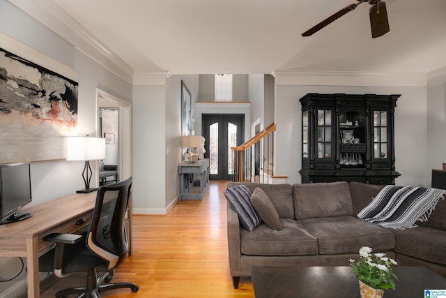 living room featuring wood-type flooring, ceiling fan, and ornamental molding