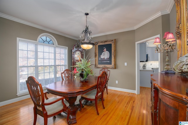 dining area with light hardwood / wood-style flooring and crown molding