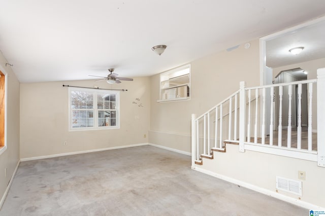 carpeted spare room with ceiling fan and lofted ceiling