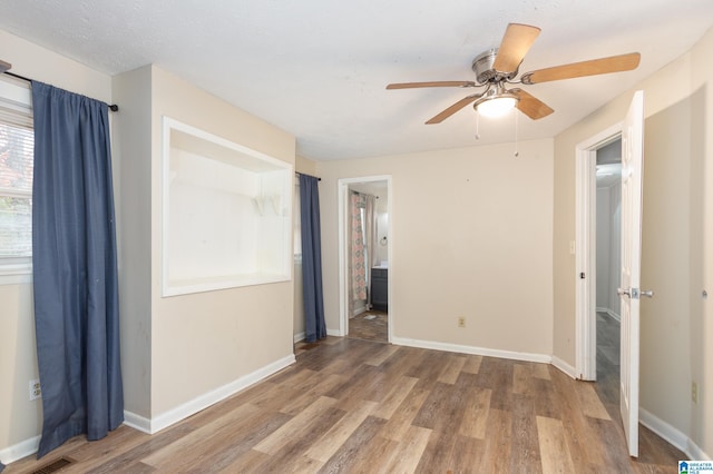 unfurnished room with ceiling fan and hardwood / wood-style flooring