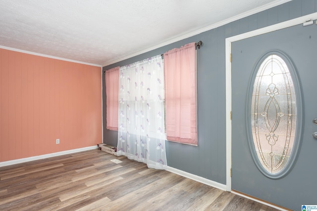 foyer entrance featuring wood-type flooring and ornamental molding