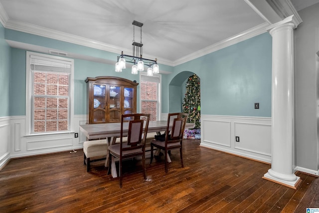 dining room featuring decorative columns, an inviting chandelier, dark hardwood / wood-style floors, and ornamental molding