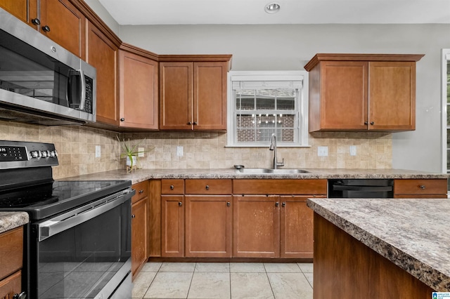 kitchen with decorative backsplash, light tile patterned floors, sink, and appliances with stainless steel finishes