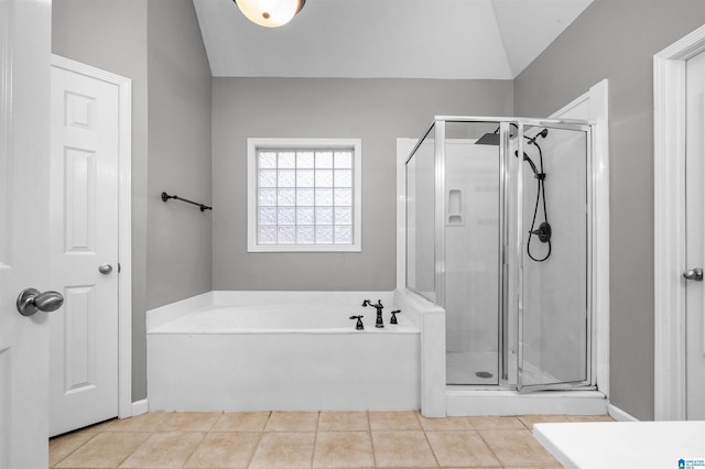 bathroom with tile patterned flooring, separate shower and tub, and lofted ceiling