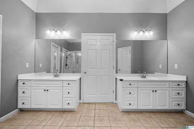 bathroom featuring tile patterned floors, vanity, and walk in shower