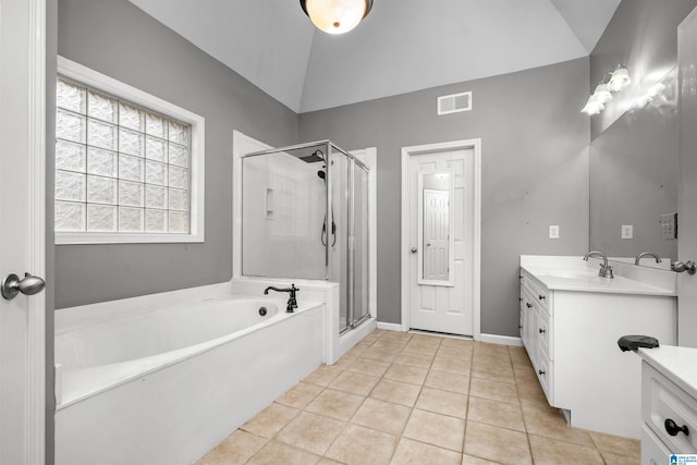 bathroom with tile patterned floors, vanity, separate shower and tub, and lofted ceiling