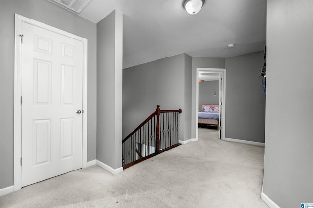 hall with light colored carpet