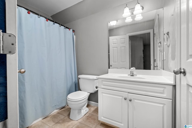 bathroom with toilet, a shower with curtain, vanity, and tile patterned floors