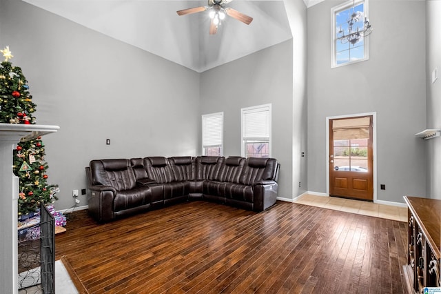 living room featuring ceiling fan, high vaulted ceiling, and hardwood / wood-style flooring