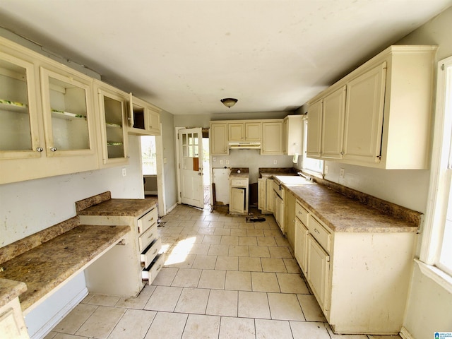 kitchen featuring cream cabinets, light tile patterned floors, and sink