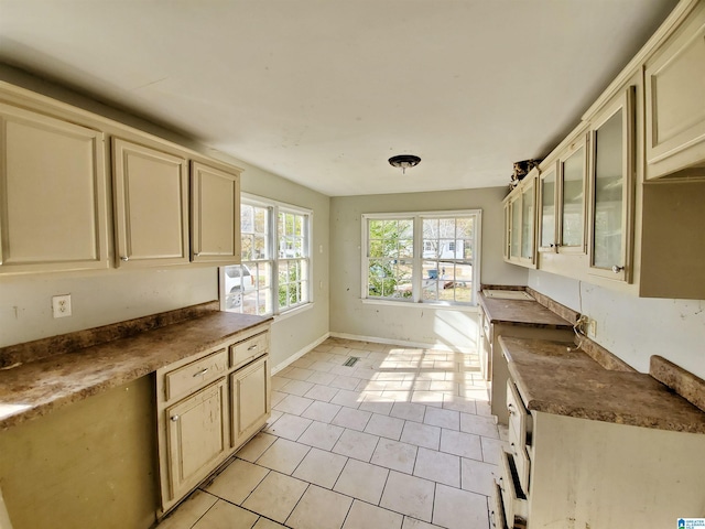 kitchen featuring cream cabinets and light tile patterned flooring