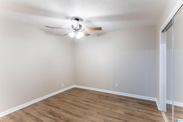 empty room featuring hardwood / wood-style floors, a textured ceiling, and ceiling fan