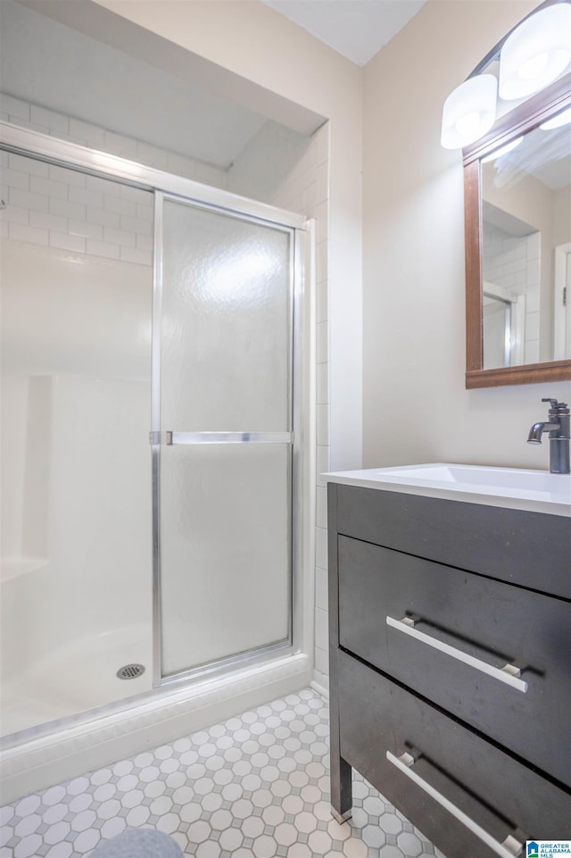 bathroom featuring vanity and a shower with shower door