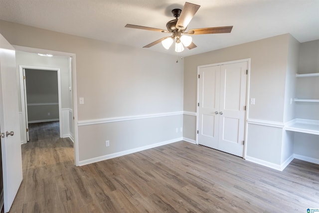 spare room featuring light hardwood / wood-style flooring and ceiling fan