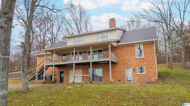 back of property featuring a lawn