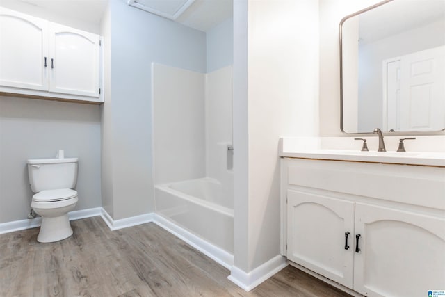 full bathroom featuring hardwood / wood-style flooring, vanity, toilet, and shower / washtub combination