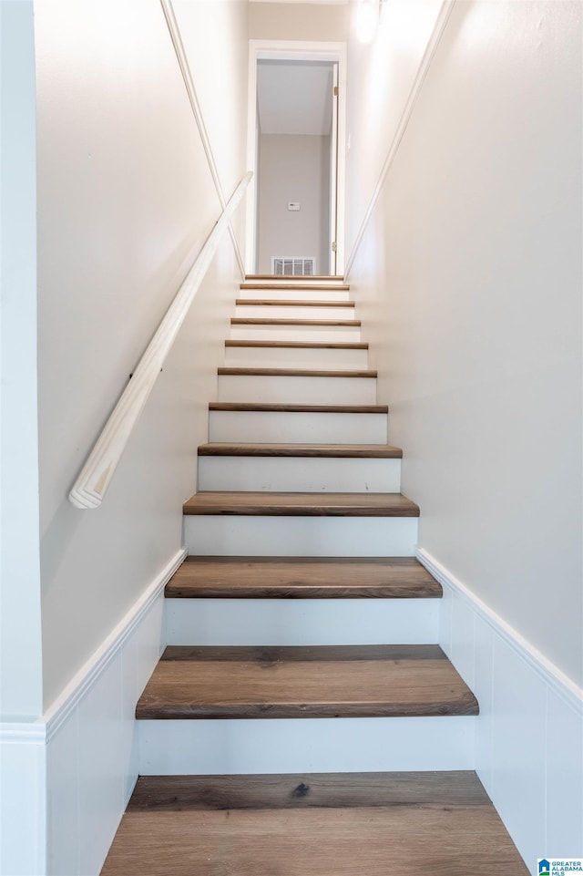 stairs featuring hardwood / wood-style flooring