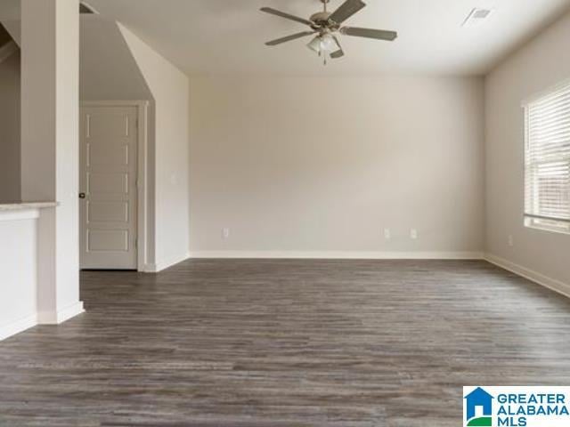 spare room with ceiling fan and dark wood-type flooring