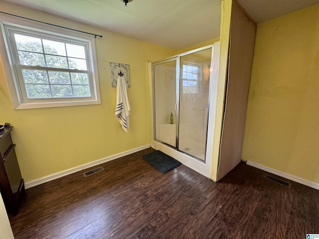 bathroom featuring wood-type flooring and walk in shower