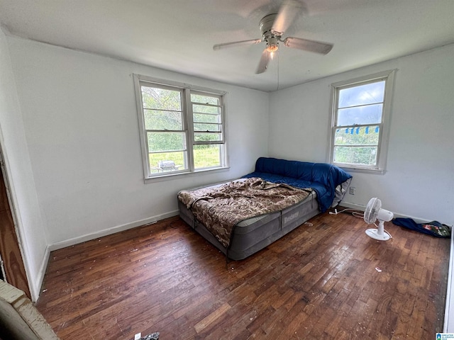 bedroom featuring ceiling fan and dark wood-type flooring