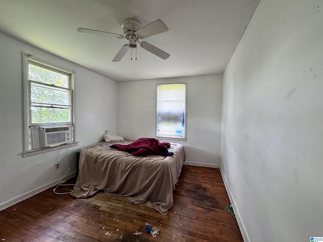 bedroom with dark hardwood / wood-style floors, ceiling fan, and cooling unit