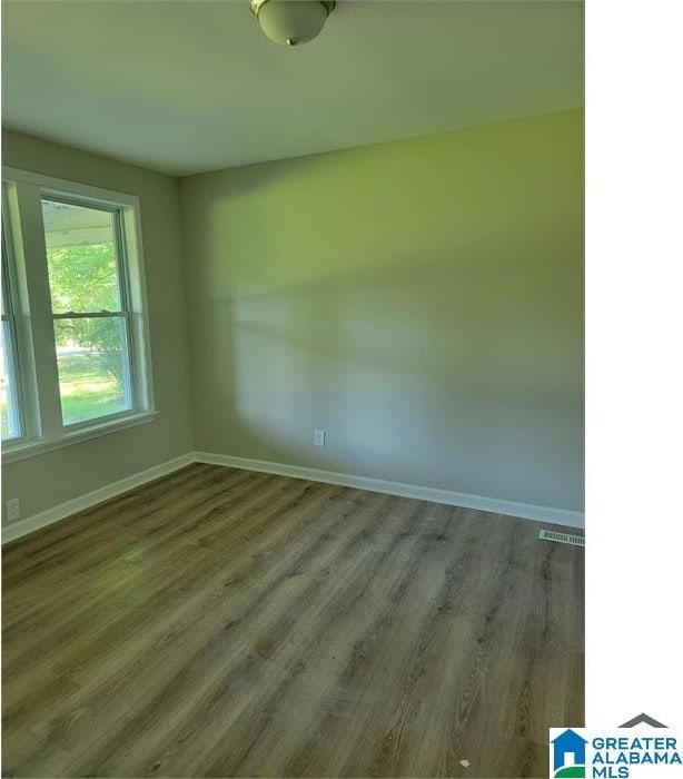 unfurnished room featuring dark hardwood / wood-style flooring