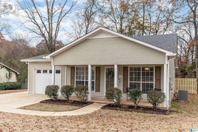 view of front of house with a porch, a garage, and central air condition unit