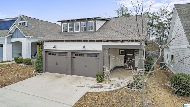 view of front of home featuring central AC unit and a garage