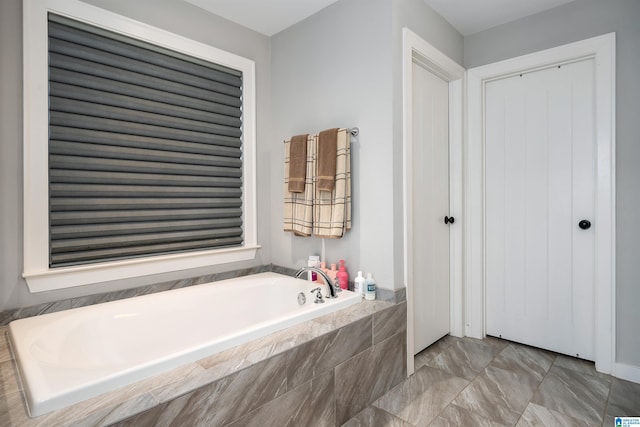 bathroom with tiled bath