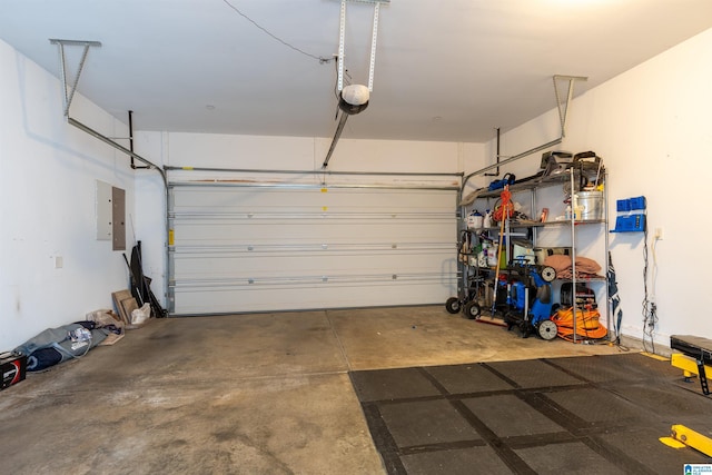 garage featuring electric panel and a garage door opener