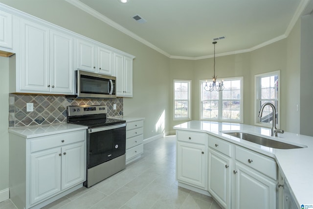 kitchen featuring white cabinets, a healthy amount of sunlight, sink, and appliances with stainless steel finishes