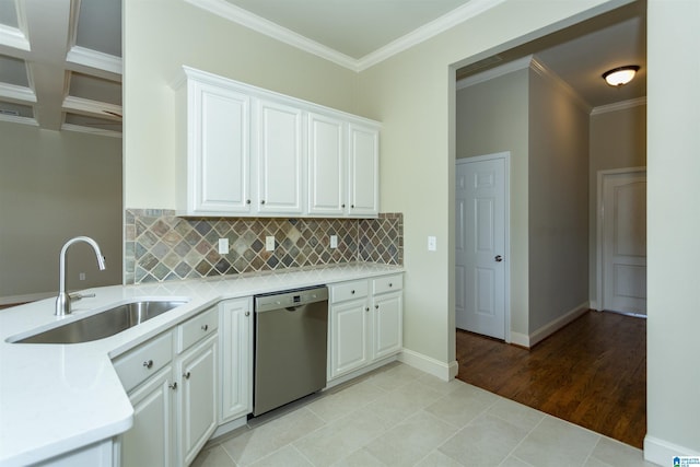 kitchen with dishwasher, white cabinetry, coffered ceiling, and sink