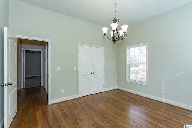 interior space featuring a closet, dark hardwood / wood-style flooring, and a chandelier