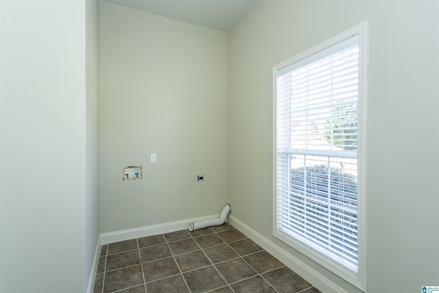 laundry area with dark tile patterned flooring, electric dryer hookup, and hookup for a washing machine