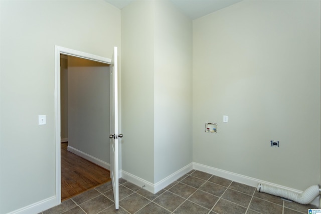 washroom with hookup for an electric dryer, dark tile patterned floors, and hookup for a washing machine