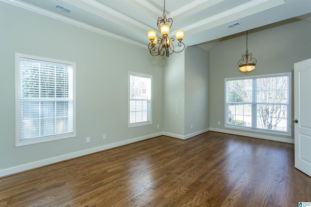 empty room featuring dark hardwood / wood-style flooring, an inviting chandelier, and a healthy amount of sunlight