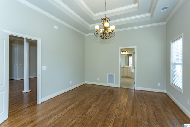 unfurnished room with dark hardwood / wood-style floors, crown molding, a tray ceiling, and an inviting chandelier