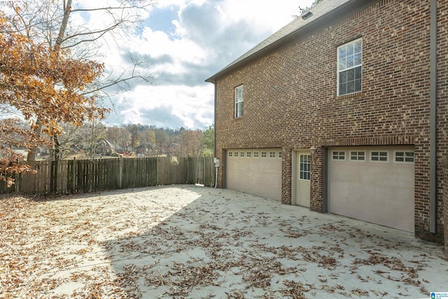 view of side of home with a garage