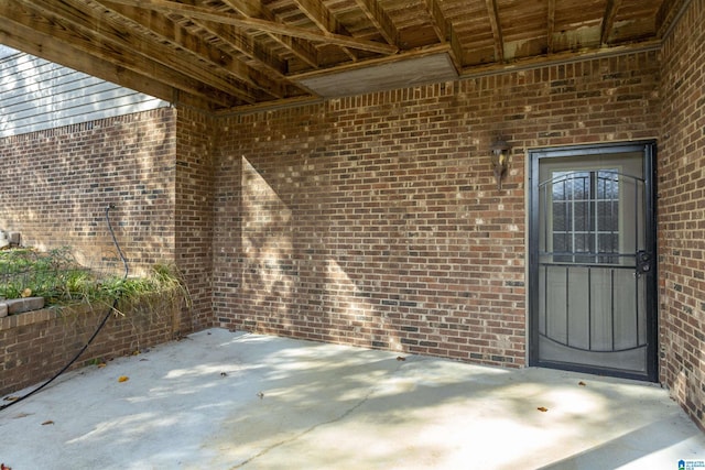 entrance to property featuring a patio